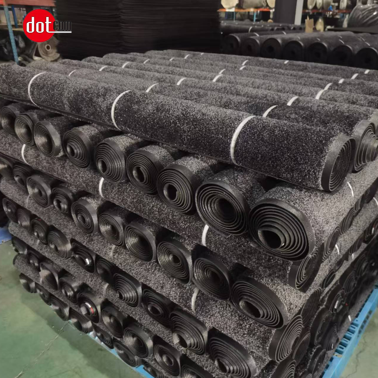 Rolls of finished entrance mats stacked in the MatCore Mats factory